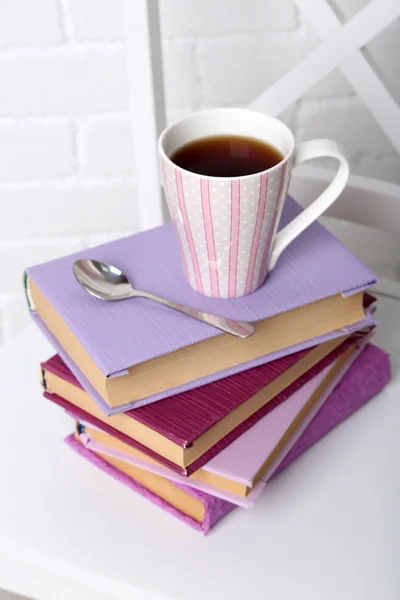 Pile of books with cup — Stock Photo, Image