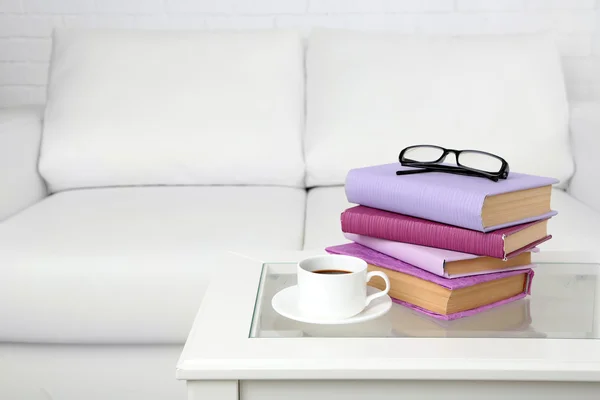 Pile of books with cup