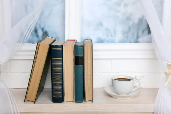 Books and cup on the windowsill — Stock Photo, Image