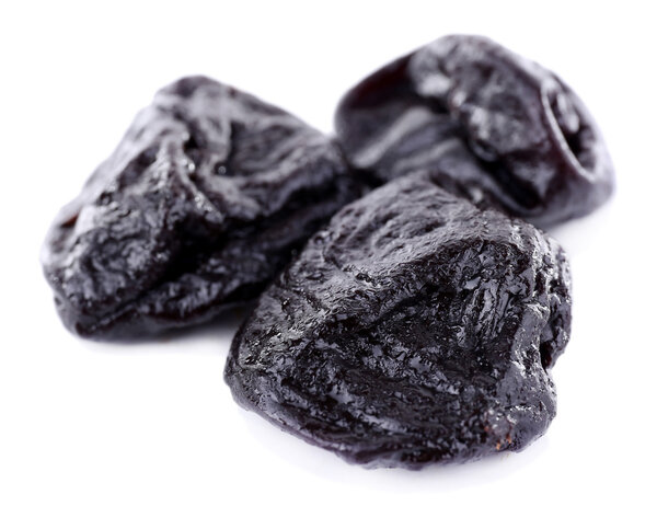 Three prunes isolated on white