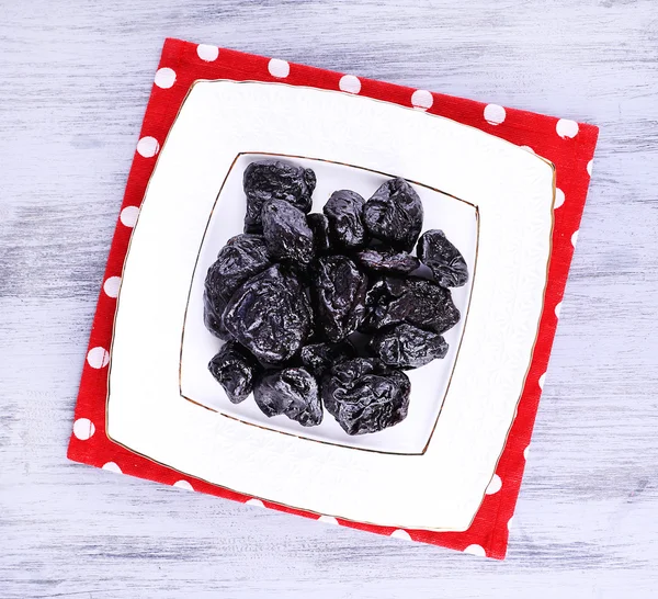 Squared white plate of prunes — Stock Photo, Image