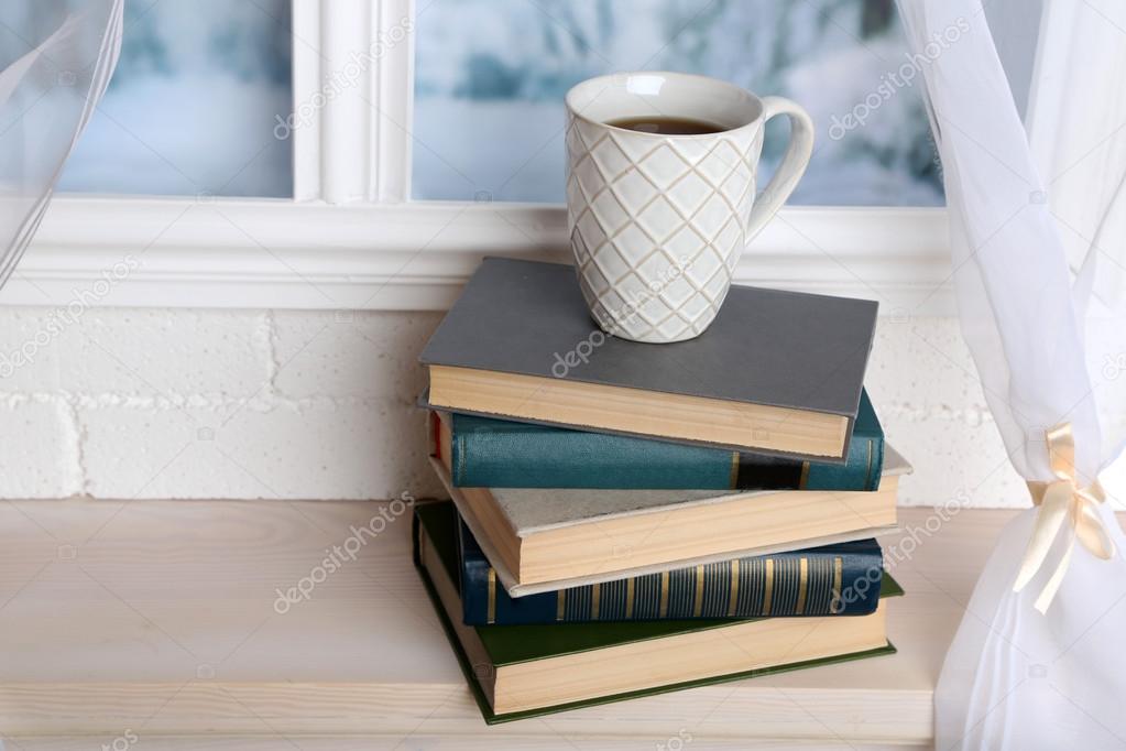 Books and cup on the windowsill