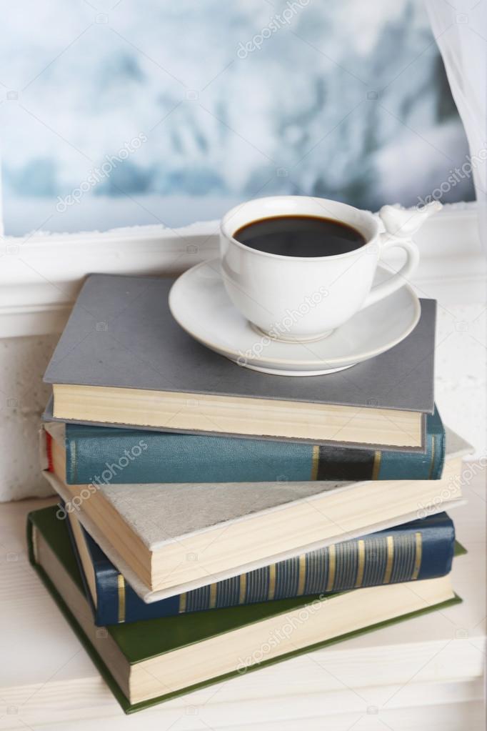 Books and cup on the windowsill