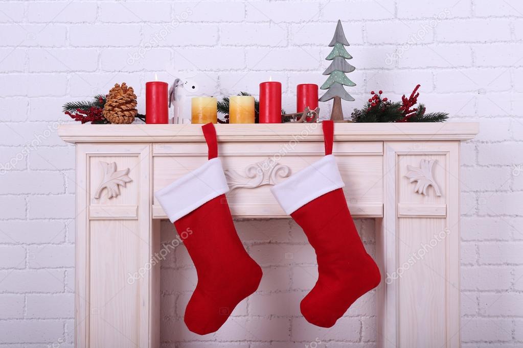 Christmas socks on fireplace Stock Photo by ©belchonock 61089591