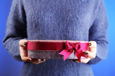 Hediye kutusu ellerinde.