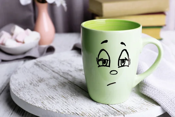 Emotional cup on wooden table — Stock Photo, Image