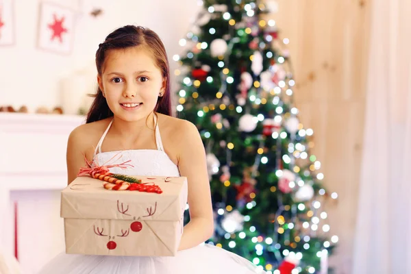 Cute little girl with Christmas gift — Stock Photo, Image