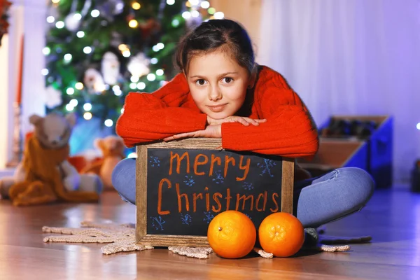 Cute little girl with greeting Merry Christmas — Stock Photo, Image