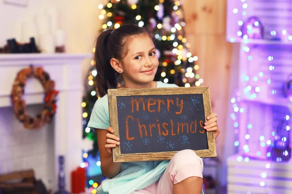 Cute little girl with greeting Merry Christmas — Stock Photo, Image