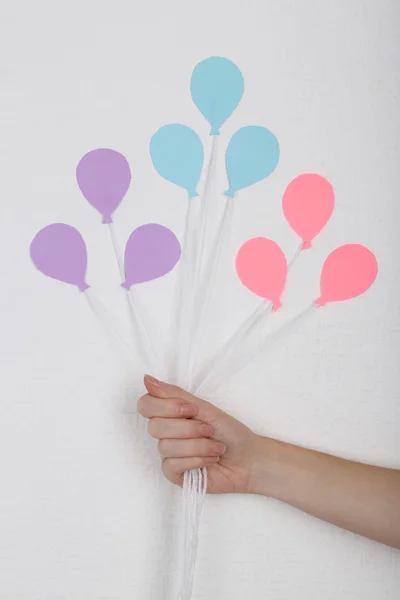 Hand holding paper balloons — Stock Photo, Image
