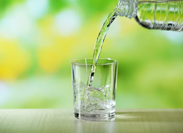 Pouring water from bottle — Stock Photo, Image