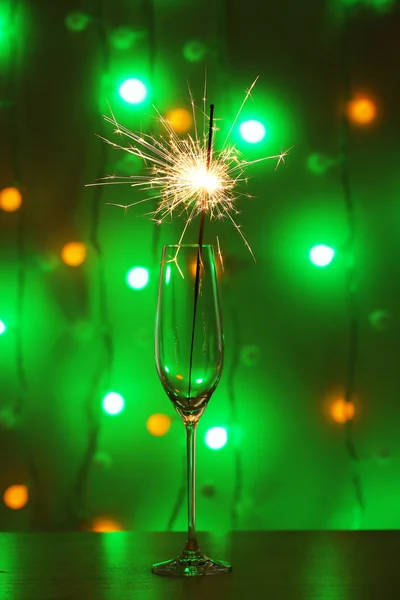 Beautiful sparkler in glass on shiny background, close up — Stock Photo, Image