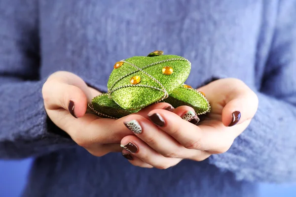 Christmas decoration in female hands — Stock Photo, Image