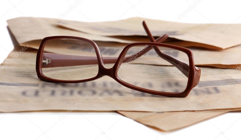 Glasses and newspapers close up