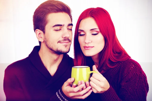 Loving couple with hot drink — Stock Photo, Image