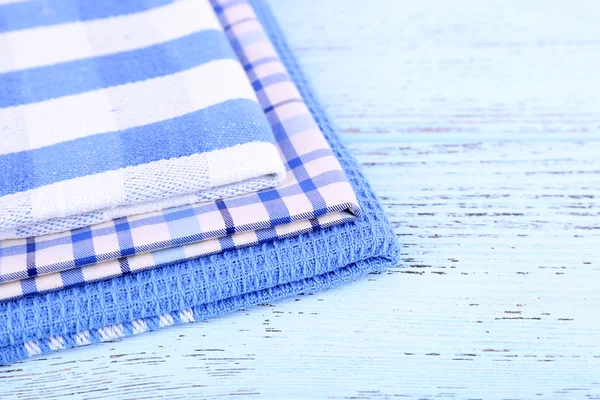 Blue napkins on wooden table — Stock Photo, Image