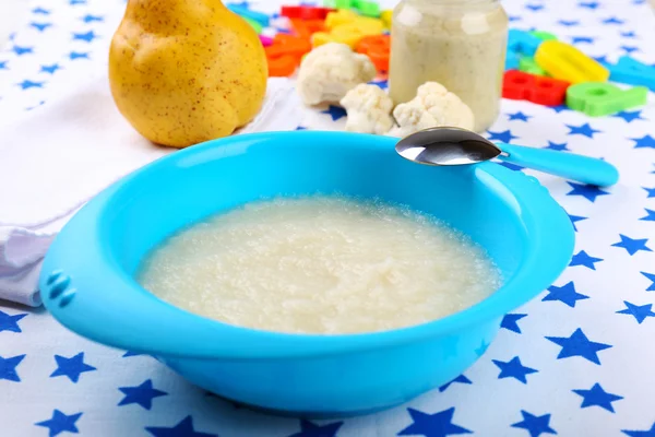 Fresh baby food in bowl with spoon — Stock Photo, Image