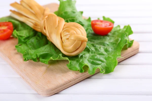 Smoked braided cheese on wooden table — Stock Photo, Image