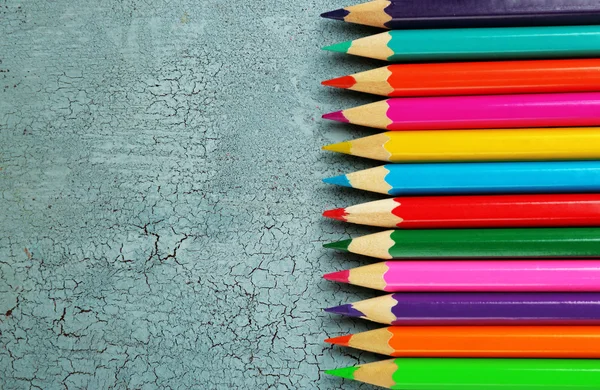 Colorful pencils on texture wooden background — Stock Photo, Image