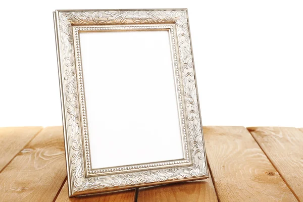 Photo frame on wooden table — Stock Photo, Image