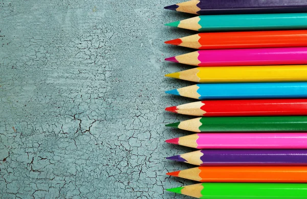 Colorful pencils on texture wooden background Stock Image