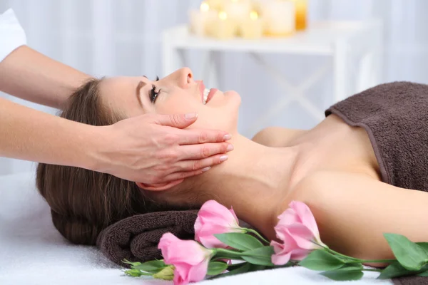 Beautiful young woman having massage in spa salon Stock Picture