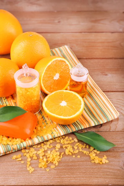 Oranges, bottles of bath salt and oil — Stock Photo, Image