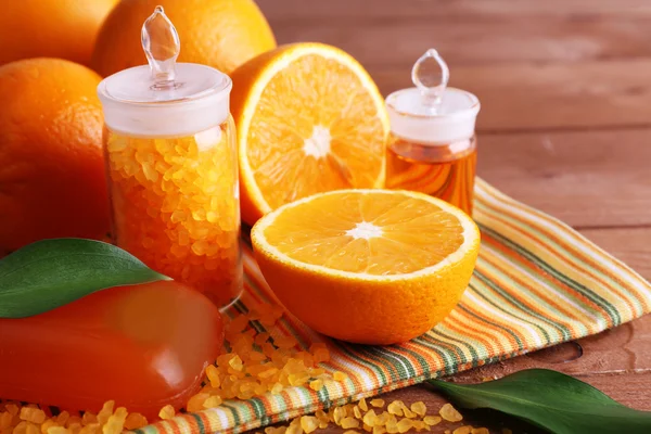 Oranges, bottles of bath salt and oil — Stock Photo, Image