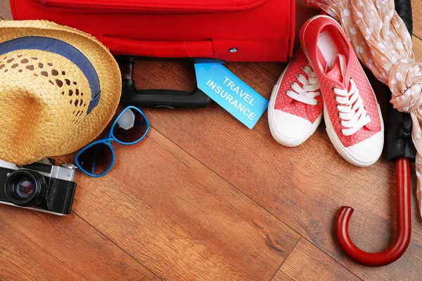 Suitcase and tourist stuff — Stock Photo, Image