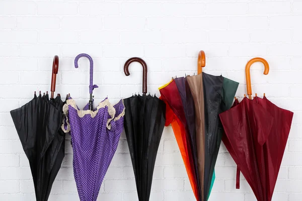 Bright umbrellas over wall — Stock Photo, Image