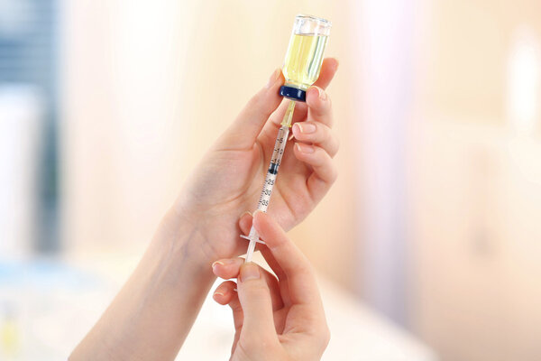 Doctor with medical syringe