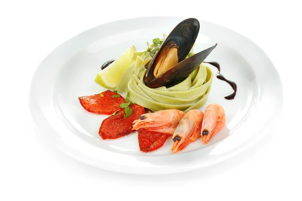 Tasty pasta with shrimps, mussels and tomatoes isolated on white — Stock Photo, Image