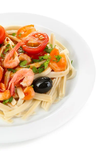 Tasty pasta with shrimps, black olives and tomatoes isolated on white — Stock Photo, Image