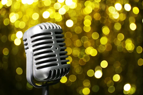 Silver microphone on golden background — Stock Photo, Image