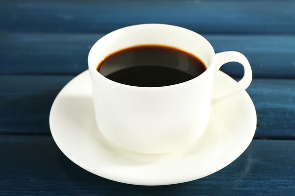 Cup of coffee with saucer on color wooden background — Stockfoto