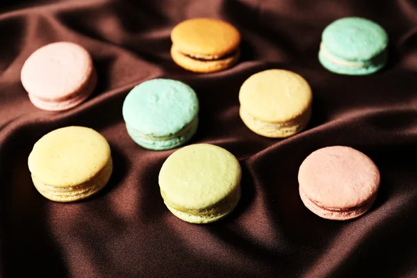 Gentle colorful macaroons on color fabric background — Stock Photo, Image