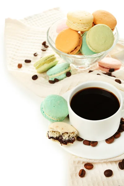 Gentle colorful macaroons in glass bowl and black coffee in mug isolated on white — Stock Photo, Image