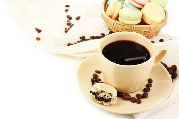 Gentle colorful macaroons in  wicker basket and black coffee in mug isolated on white — Stockfoto