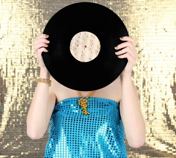 Young woman holding retro record