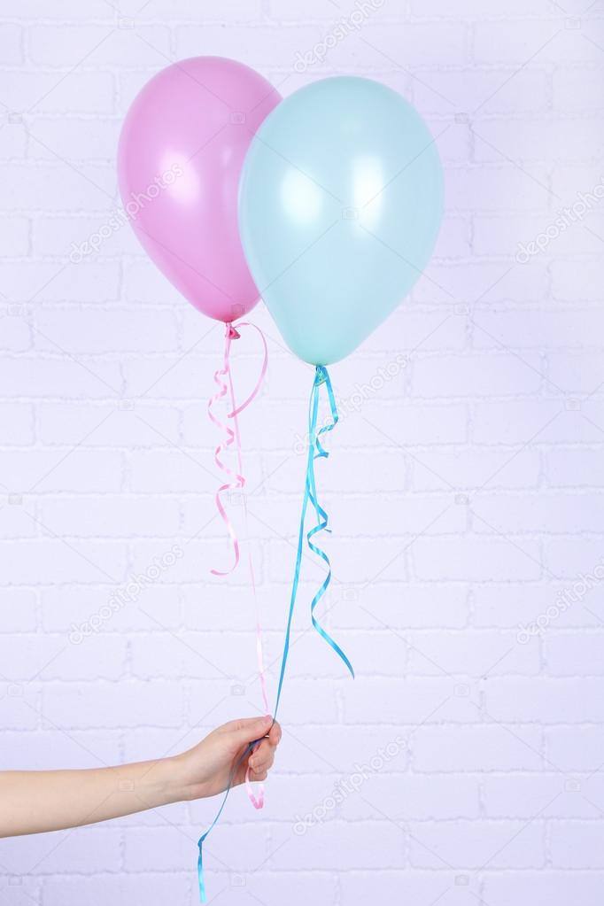 Hand holding balloons