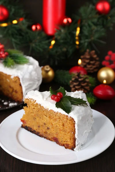 Rebanada de crema cubierta de pastel con decoración de Navidad sobre fondo de mesa de madera — Foto de Stock