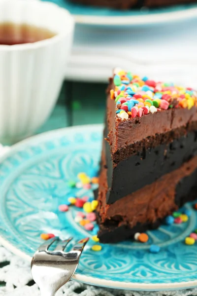 Pastel de chocolate con colorido polvo dulce en primer plano de la mesa — Foto de Stock