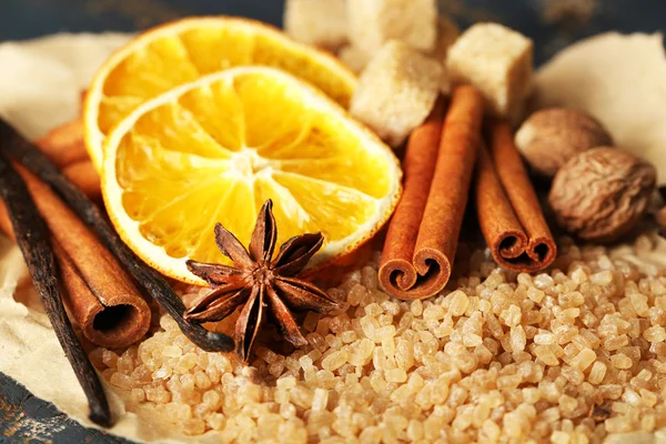 Christmas spices and baking ingredients on wooden background — Stock Photo, Image