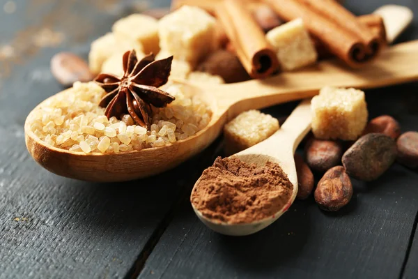 Christmas spices and baking ingredients on color wooden background — Stock Photo, Image