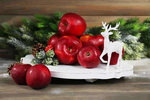 Christmas apples on wooden table — Stock Photo, Image