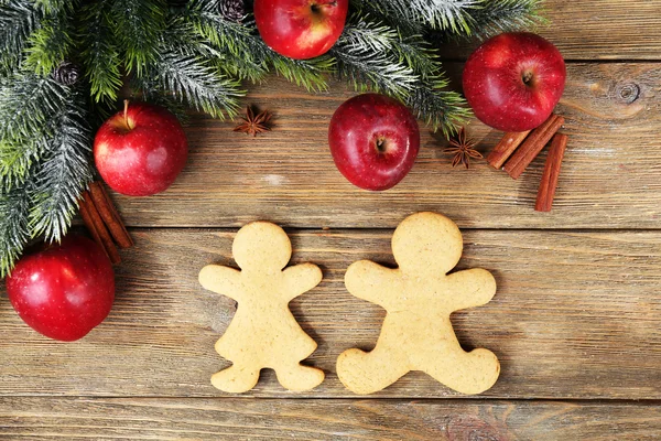 Christmas cookies and fruits on wooden table — Stock Photo, Image