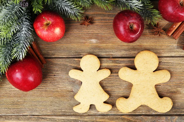 Christmas cookies and fruits on wooden table — Stock Photo, Image