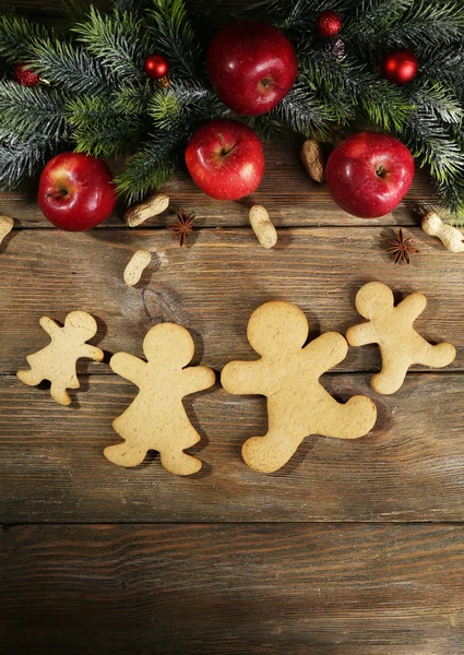 Christmas cookies and fruits on wooden table — Stock Photo, Image