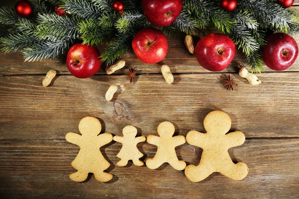 Christmas cookies and fruits on wooden table — Stock Photo, Image