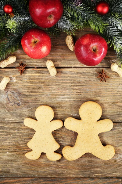 Christmas cookies and fruits on wooden table — Stock Photo, Image